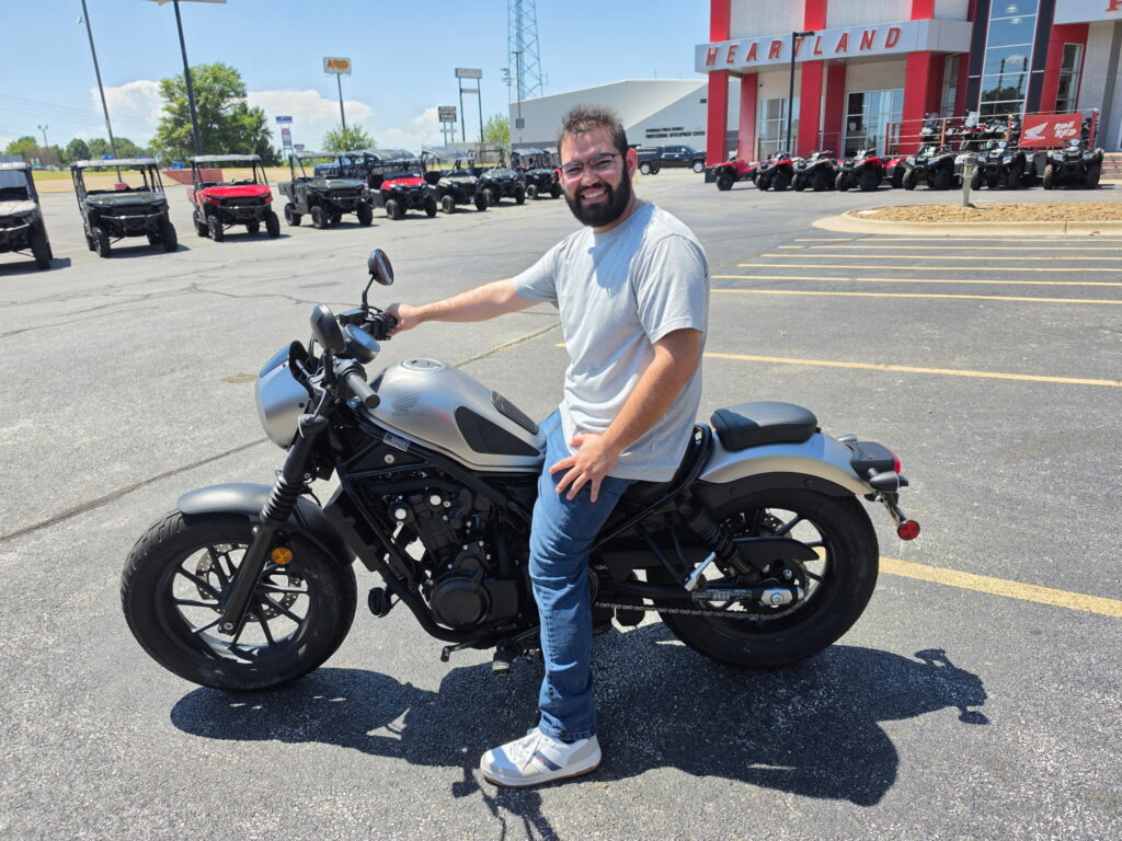Migel Moreno with his pre-owned 2022 Honda Rebel 500 SE cruiser motorcycle at Heartland Honda.