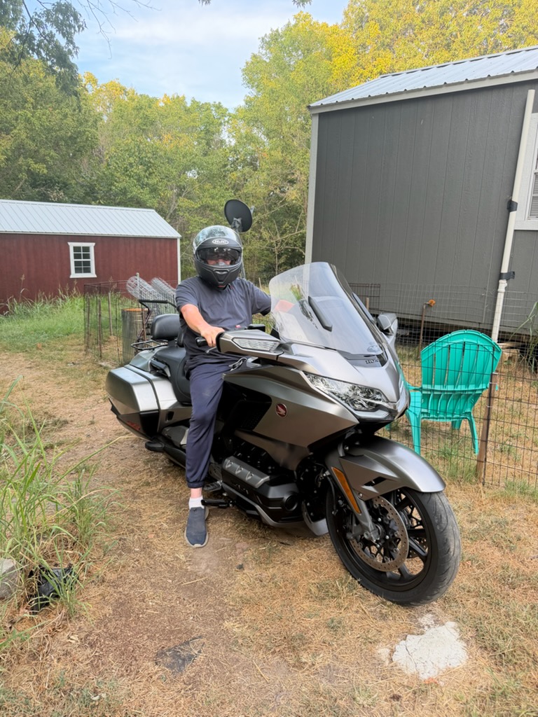 Jeremy Lloyd with his pre-owned 2018 Honda Gold Wing DCT touring motorcycle at Heartland Honda
